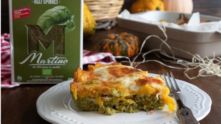 Baked spinach couscous with pumpkin, ham, and cheese